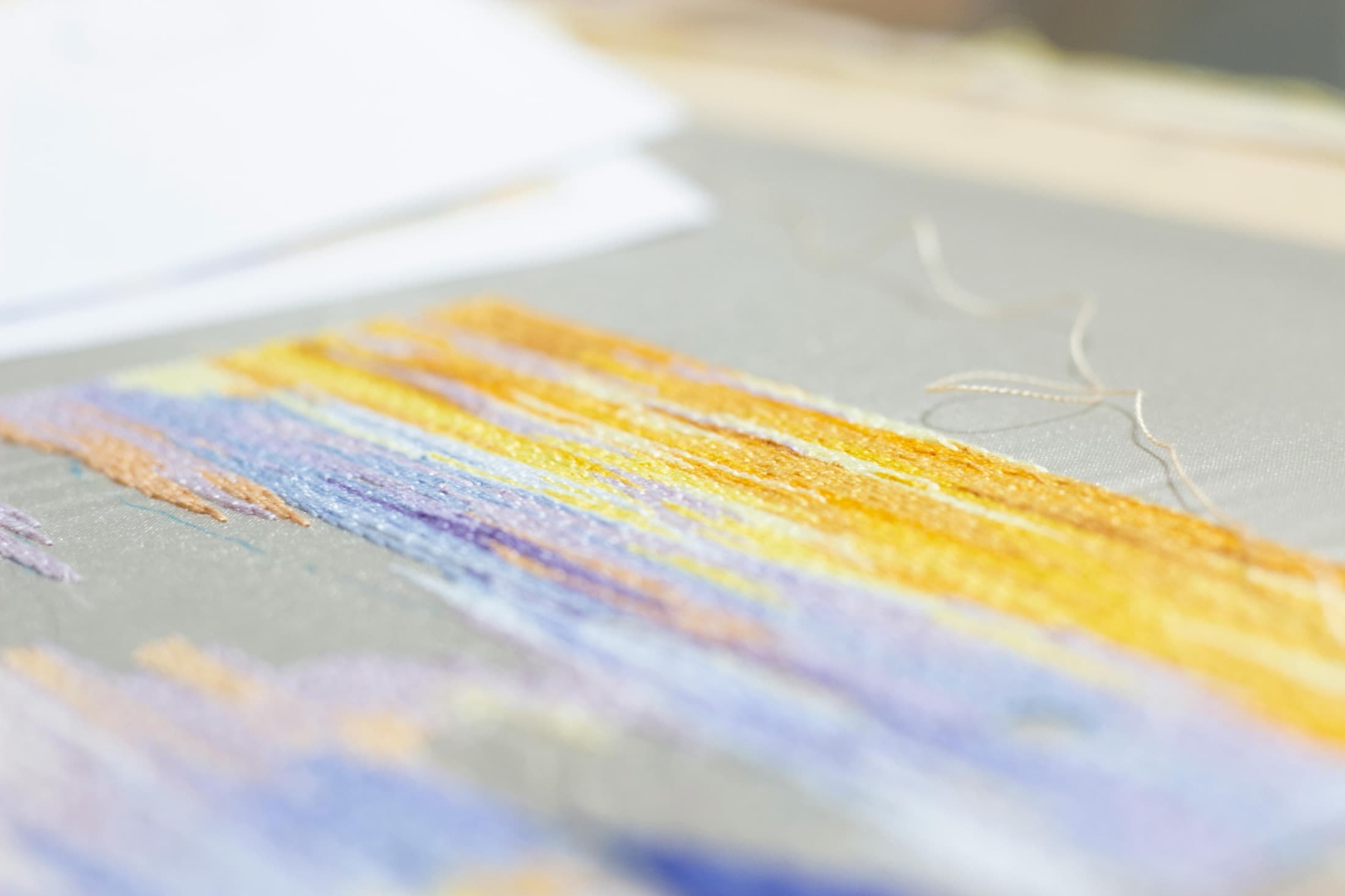 Cinematic close-up of embroidery texture and fabric